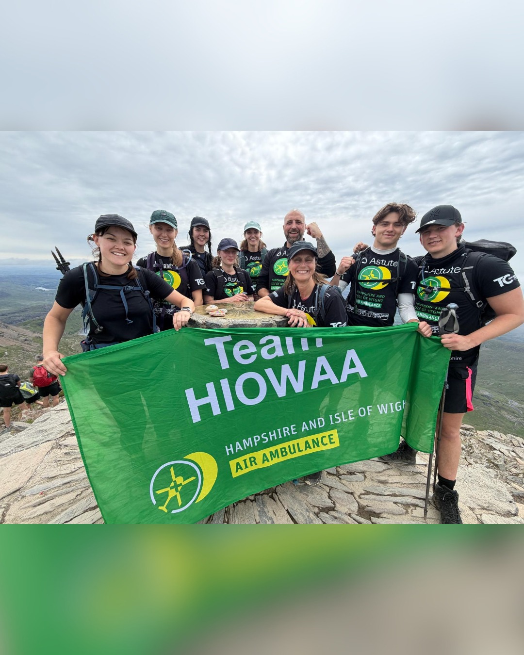 The team at the summit with the Team HIOWAA air ambulance banner